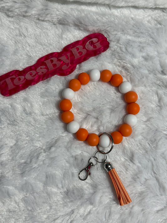 Orange and White Wristlet with silver hardware, orange tassel